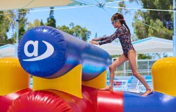 Child walking on pool inflatable